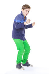 casual cool teenage boy clenches his fistst, isolated on white