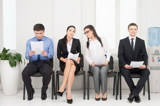 Four different people waiting for interview