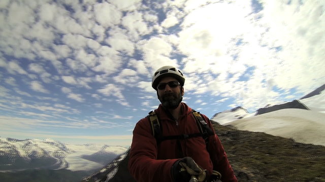 Mountaineer maneuvering selfie video camera, Alaska, USA 
