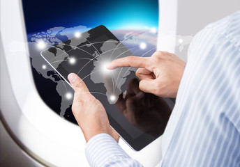 Businessman  in airplane pressing social network communication