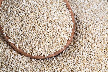 white quinoa on wooden background