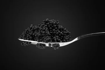 Zelfklevend Fotobehang Black caviar in metal teaspoon. Macro photo © evannovostro