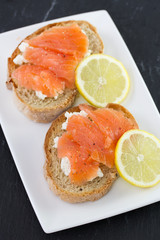 Naklejka na ściany i meble sandwich with salted salmon and lemon