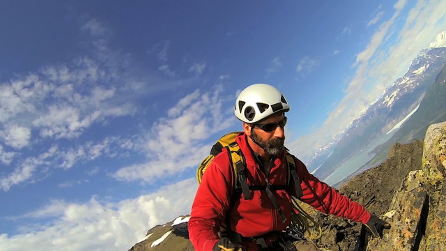 Climber filming selfie to post online, Alaska, USA 