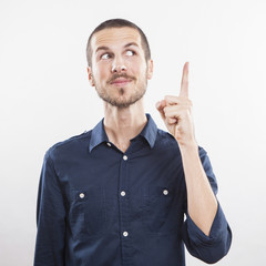 young man pointing up, showing something, having an idea