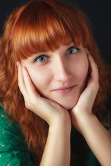 Fototapeta premium red-haired girl on a dark background