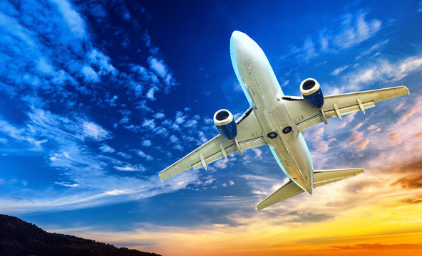 Fototapeta Airplane transportation. Jet air plane flies in blue sky