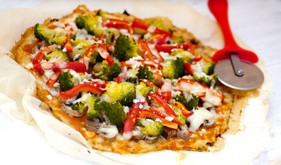 Pizza with vegetables on paper