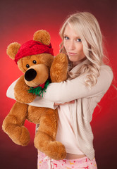 beautiful blond girl holding a teddy bear