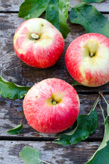 Red apples on a wooden background
