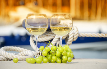 Wineglasses and grapes on the yacht pier of La Spezia, Italy