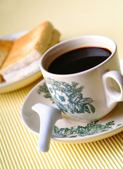 warm cup of coffee on the brown background