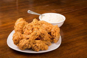 Fried Chicken with Spoon in Bowl of Mashed Potatoes