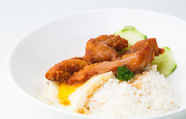 Chicken with rice and vegetables in background