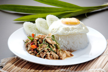 Chicken with rice and vegetables in background