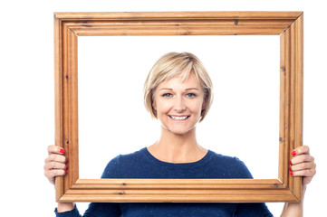 Middle aged lady holding photo frame