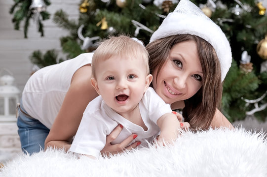Mom with a child under the Christmas tree