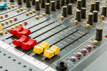 Closeup on sliders of sound mixing console in audio recording