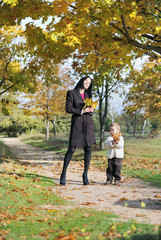 Fototapeta premium little boy with his mother in autumn park