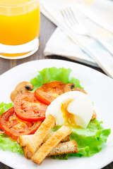 Light breakfast with soft egg, tomato and croutons