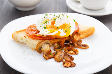 Poached egg with mushrooms and tomatoes