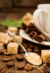 Cane sugar in a silver spoon with coffee