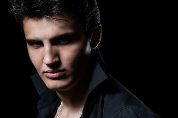 Obraz premium Portrait of a young handsome man on dark background