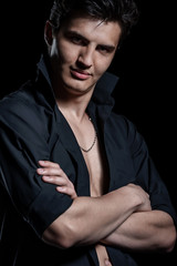 Portrait of a young handsome man on dark background