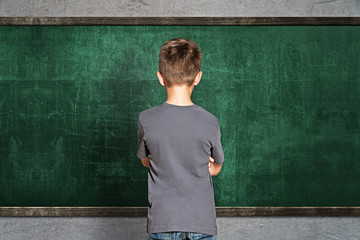 Child in front of empty Blackboard