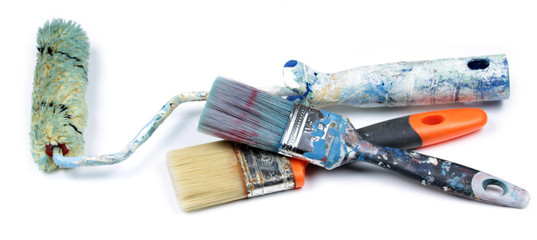 Used paint roller and brushes, isolated on white background