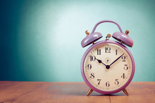 Retro clock on table front gradient mint green background