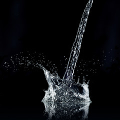 Water splash isolated on black background. High resolution