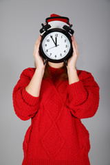 Girl with big clock instead of face at light