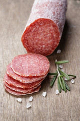 italian salami sausage slices with rosemary and sea salt