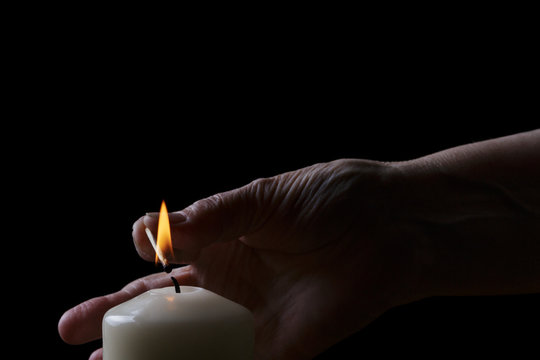 Old Woman Hand Set Fire A Candle