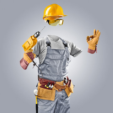 invisible worker in helmet with drill