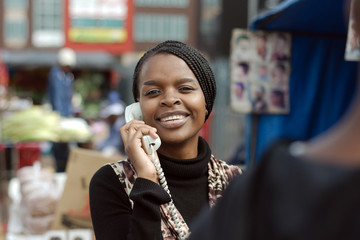 Naklejka premium African or black American woman calling on landline telephone