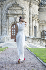 Young woman in a white long dress