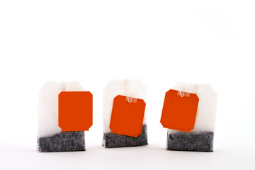 three tea bags on white background