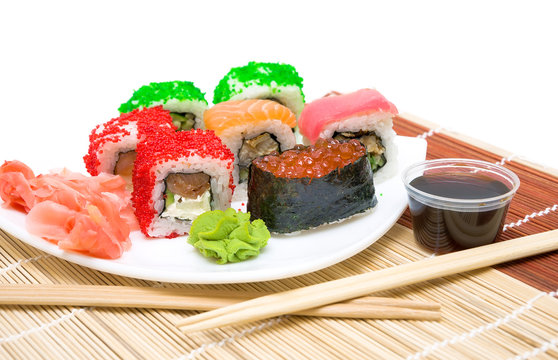sushi with red caviar and rolls close up on a white plate