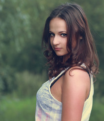 Fototapeta premium Beautiful woman outdoors. Closeup vintage color portrait