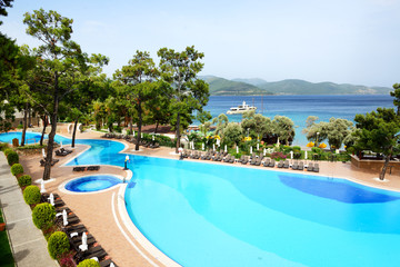 Swimming pool and yacht at the pier on Mediterranean turkish res