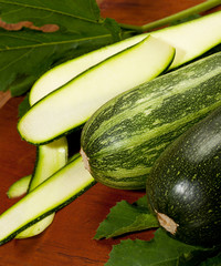 fresh green zucchini on wooden background