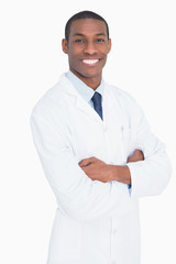 Portrait of a smiling male doctor with arms crossed