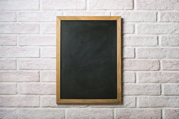 Chalk board on a white brick wall