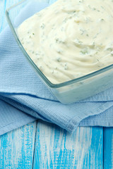 Sour cream in bowl on table close-up