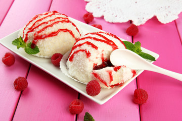 Delicious coconut cakes on plate on table close-up