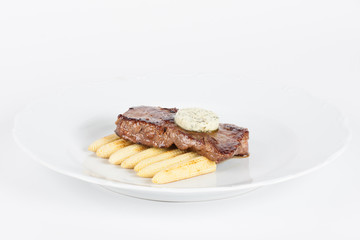 Delicious beef steak on white plate with corn