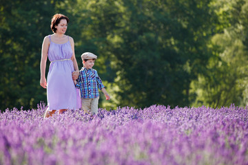 Young woman and her little son in lavender field