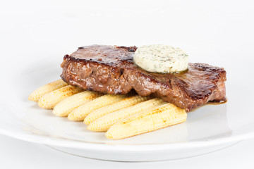 Delicious beef steak on white plate with corn